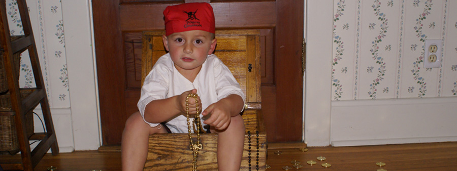 Child sitting in treasure chest